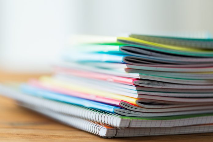 close up of notebooks on wooden table